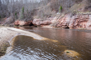  Red rocks and river Gauja. Nature and sun in spring. 2019.