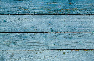 A fence of dark blue and grey turquoise boards. Blank background with a texture of wooden slats