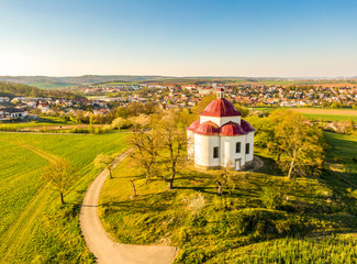 Aerial view of baroque chapel near Rosice city, Czech republic. Catholic religion building is national heritage of Czech republic. Sunny weather, agriculture land in background