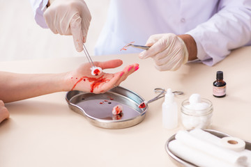 Hand injured woman visiting male doctor 