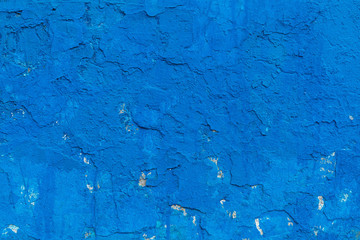Impressive background. The surface has a multilayered plaster covering. The paint of blue color which cracked in places