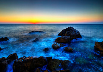 Beautiful sunrise over rocky shore