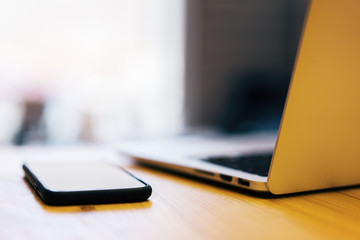 Blurry laptop and smartphone