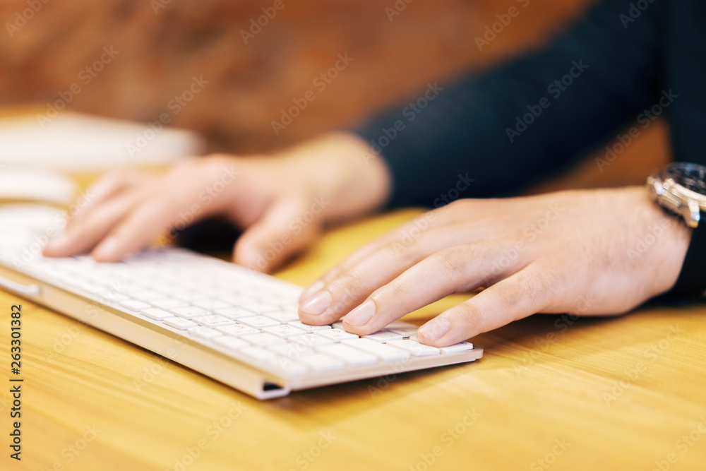 Poster sideview of businessman hands using keypad
