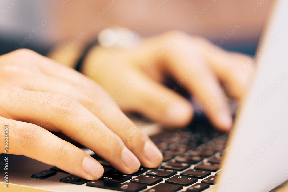 Poster sideview of man using laptop on table