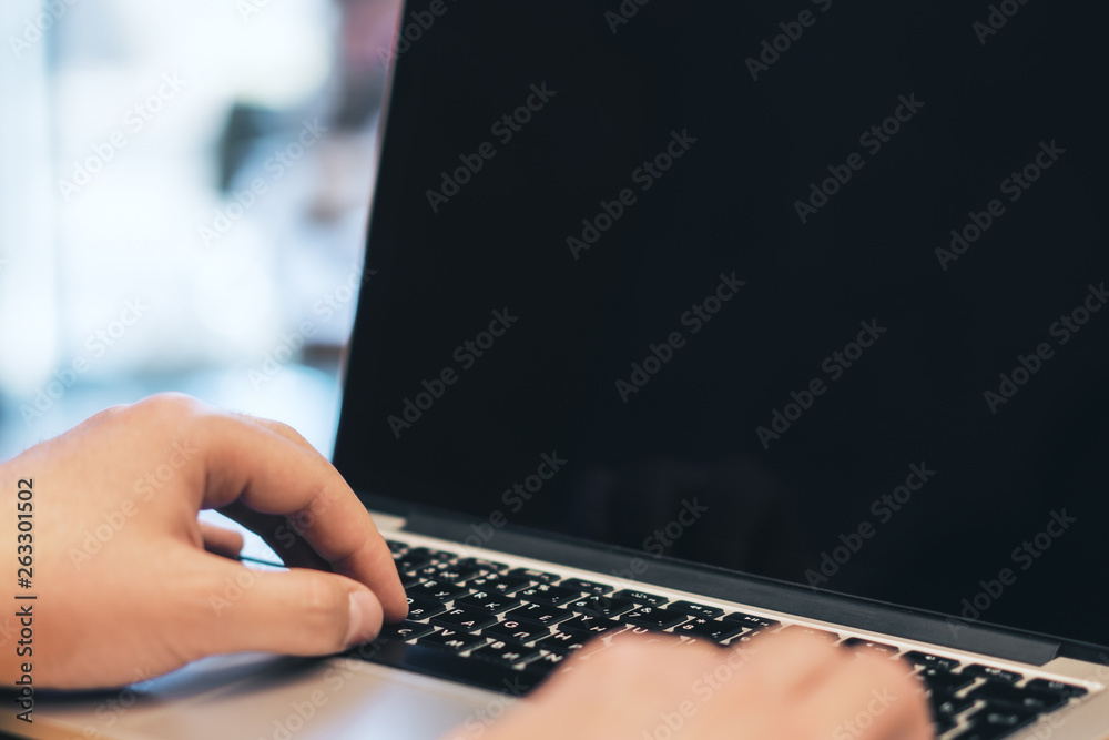 Poster man using empty laptop screen on desk top