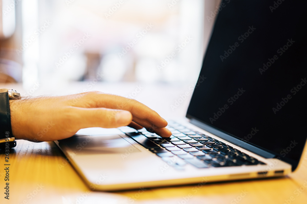 Poster man using empty notebook screen on desktop