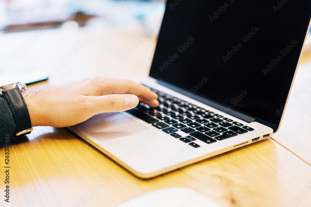 Poster man using empty laptop screen on table