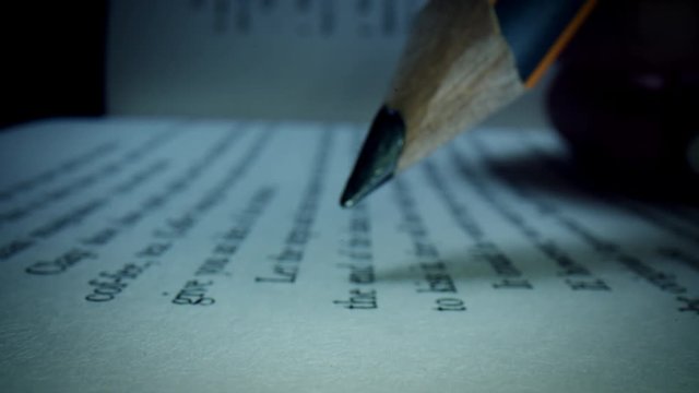 4k Macro Close-up Through a Book with a Pencil Highlighting 