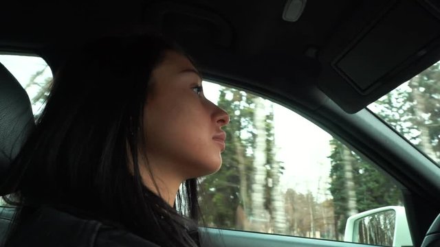 Beautiful girl behind the wheel close-up.