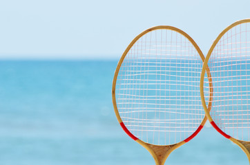 Close-up badminton rackets at the seaside, summer photo,sport