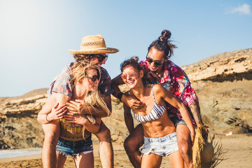 Cheerful people two couples laugh and have fun together - friends enjoying the summer holiday...