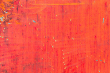 Obraz premium Abstract background of red color. The drawing in the form of tongues of flame from the peeled paint and scratches on metal texture