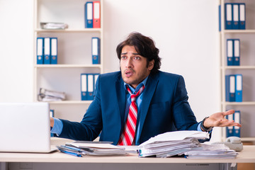 Fototapeta premium Young handsome businessman sitting in the office 