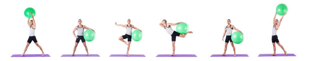 Man with swiss ball doing exercises on white