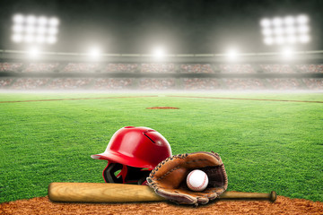 Baseball Bat, Helmet, Glove and Ball on Field in Outdoor Stadium With Copy Space