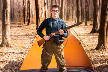 Autumn hunting season. Man hunter with a gun. Hunting in the woods