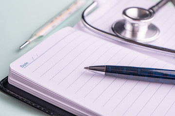 stethoscope (phonendoscope) a pen and glasses. The concept of the doctor's desktop