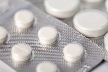 packing of white tablets, Packs of white pills packed in blisters