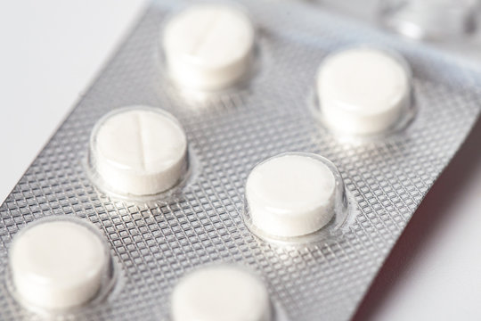 packing of white tablets, Packs of white pills packed in blisters