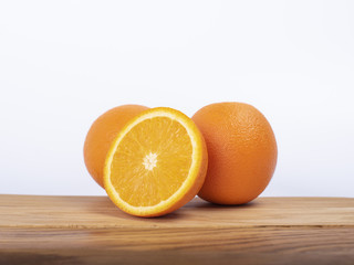 Orange on a wooden board, cut in half