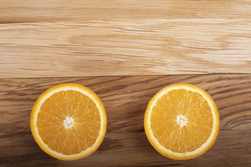 Orange on a wooden board, cut in half