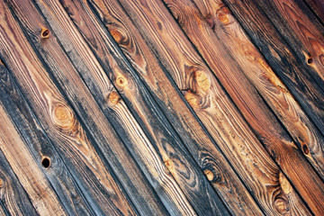 Naklejka premium The wall of old logs and boards natural wood. Diagonal boards create a pattern with natural pine texture.