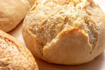 Assortment, different kind of wheat baked bread with golden crust on the table