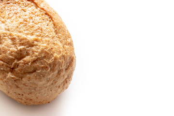 Cropped baked wheat baguette with golden crust on white background with copy space, bakery and grocery concept