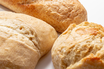 Assortment, different kind of wheat baked bread with golden crust on the table