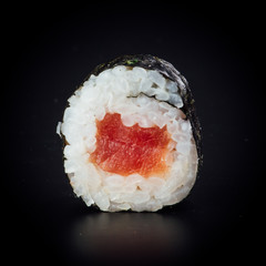 Tuna maki sushi rolls on a black background, japanese food © nehopelon