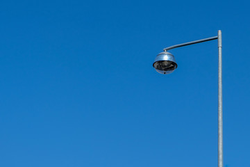 street lamp in front of blue sky