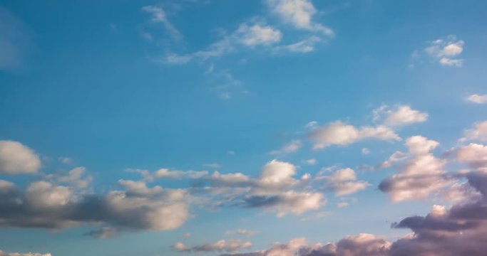 Time lapse clip of gray fluffy curly rolling clouds in windy weather in the evening
