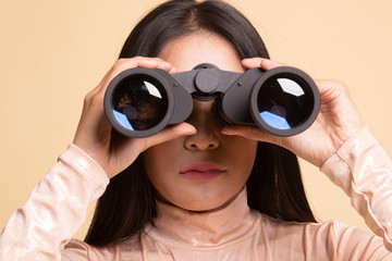 Young Asian woman with binoculars.