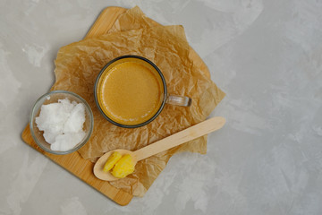 Bulletproof coffee with ghee oil and coconut oil on neutral background. Image with copy space.