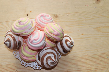 Marshmallow and whipped cream biscuits, selective focus. Tasty crumbly homemade cakes with tea on a sunny background.