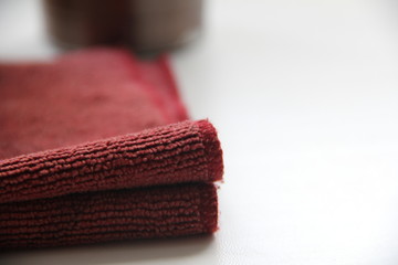edge of burgundy towels in macro shooting on a bright table