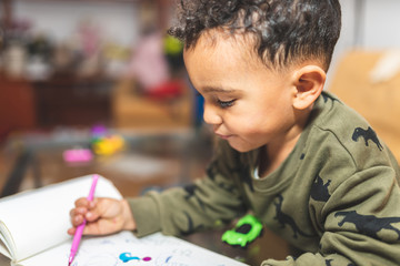 Little Boy Drawing on a Notebook.