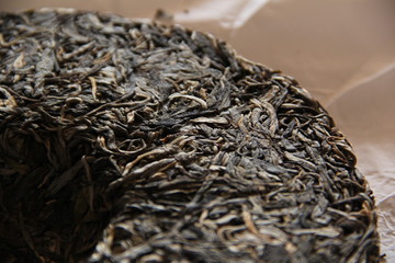 pressed tea in round cake on parchment paper