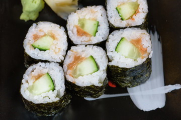 sushi roll of cucumbers and umekyu served on a black plate