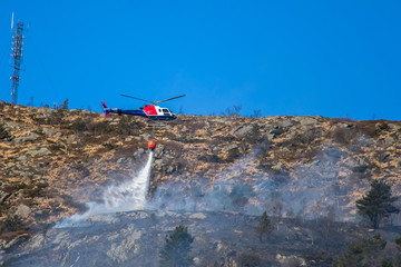 Helicopter extinguishing wildfire. Bergen, Norway.