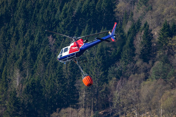 Fototapeta na wymiar Helicopter extinguishing wildfire. Bergen, Norway.