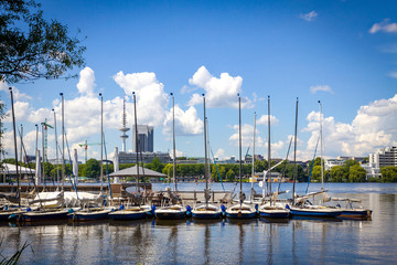 Fototapeta na wymiar Waterfront of Aussenalster Lake in Hamburg city, Germany. Lake and its shores are used by Hamburg inhabitants for many sport and recreational purposes, such as sailing and rowing