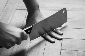 Woman closeup cutting the fingers with knife