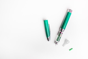 Diabetes green pen injection needle isolated on white background.