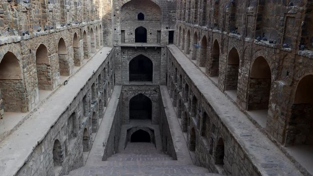 a tilt up shot of agrasen ki baoli stepwell in delhi, india