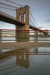 Brooklyn bridge at sunset from east river pier with reflection ,long exposure