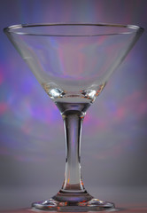 Martini Glass with flashing bright violet and red lights on background