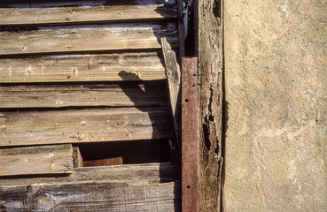 Surface detail of weathered wooden planks and cement