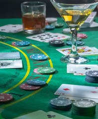 Setup for playing Blackjack at the Casino. WHisky and Martini glasses on the table.